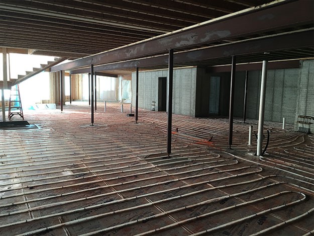 Radiant floor heating being installed in basement
