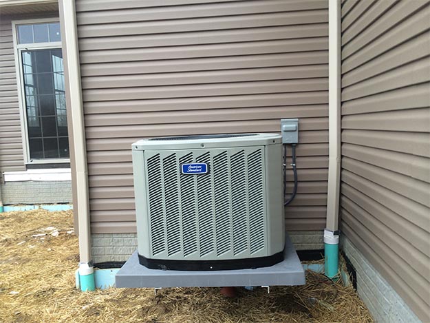 Residential Air Conditioning Unit Anchored to Foundation