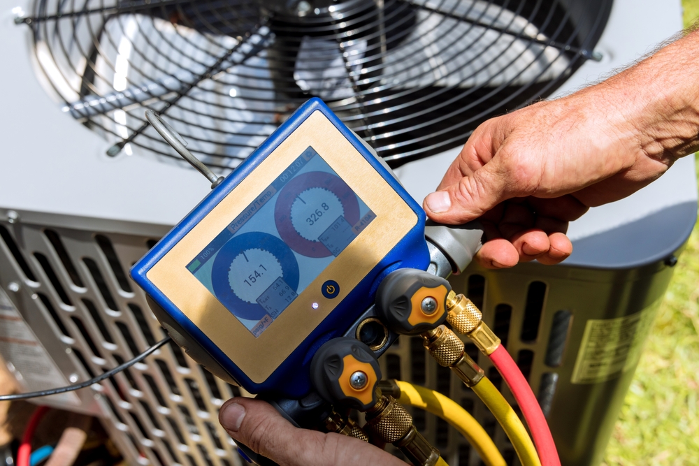 Professional technician testing a newly installed AC system